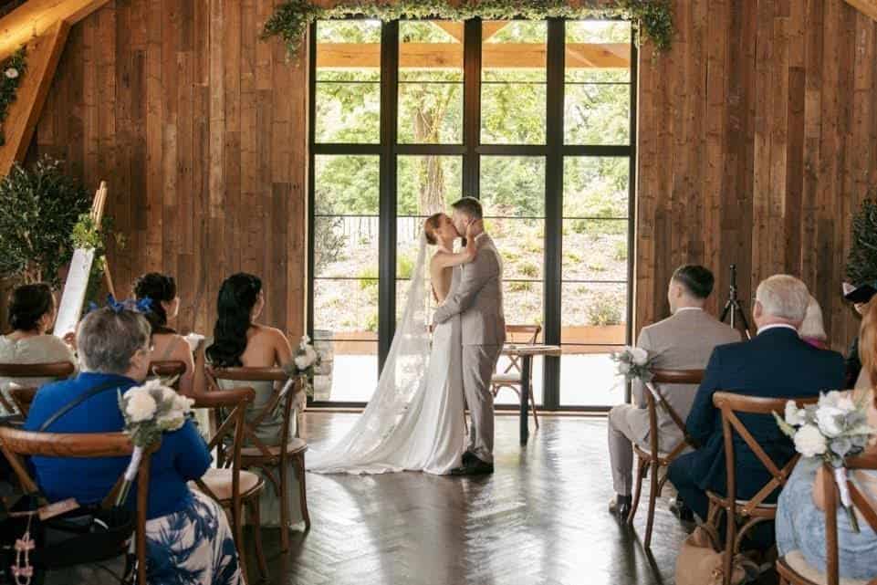 Couple exchanging vows under the trees at Drumhierny's outdoor ceremony space